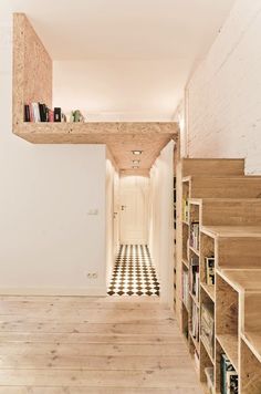 the hallway is lined with bookshelves and shelving