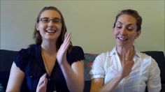 two women sitting on a couch and clapping