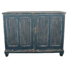 an old blue wooden cabinet with three doors