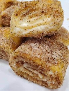 some sugar covered doughnuts stacked on top of each other