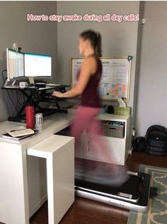 a woman standing in front of a computer desk