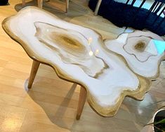 three tables made out of agate and gold leafed wood with white marble tops