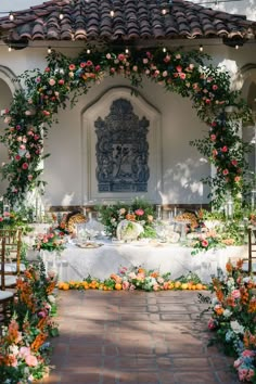 an outdoor wedding setup with flowers and greenery