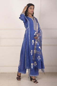 Sky blue chanderi anarkali featuring all over block printed mughal floral motifs highlighted with dori embroidery. Comes with palazzo and dupatta.
Components: 3
Pattern: Block Print, Embroidered
Type Of Work: Floral, Dori
Neckline: Notched
Sleeve Type: Three quarter
Fabric: Anarkali: Chanderi, Palazzo: Cotton, Dupatta: Organza 
Color: Sky Blue
Other Details: 
Length:
Anarkali:  48 Inches
Palazzo: 38 Inches
Dupatta: 2.5 Mtr 
Occasion: Sangeet,Mehendi and Haldi - Aza Fashions Indigo Traditional Designer Kurta, Traditional Indigo Kurta For Designer Wear, Semi-stitched Cotton Silk Blue Anarkali Set, Blue Palazzo Set With Pallu And Straight Kurta, Blue Slub Silk Traditional Bollywood Wear, Festive Blue Palazzo Set With Zari Work, Traditional Cotton Silk Churidar With Sheer Dupatta, Blue Slub Silk Churidar For Wedding, Blue Bollywood Anarkali Set With Gota Work