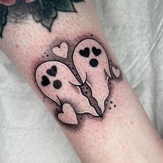 a couple of ghost faces with hearts on their arms and legs tattoo by the artist