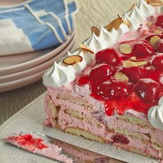 a piece of cake with cherries and nuts on top is sitting on a plate