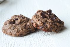 two chocolate chip cookies sitting on top of each other