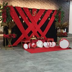 a red and white wedding set up with decorations