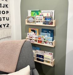 the bookshelf is made out of wood and has three shelves for children's books