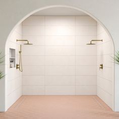 a bathroom with a white wall and tiled floor, two planters on either side of the shower