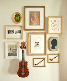 there are two pictures with guitars hanging on the wall and one has a guitar in it