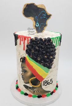 a decorated cake with an african woman's head on top