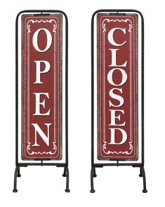 two red signs with the words closed and open on each side, standing next to each other