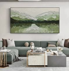 a living room filled with furniture and a painting on the wall above it's coffee table