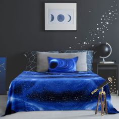 a bed room with a neatly made bed next to a night sky painting on the wall