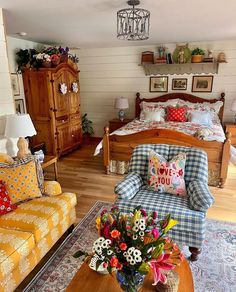 a living room filled with lots of furniture and flowers on top of a coffee table