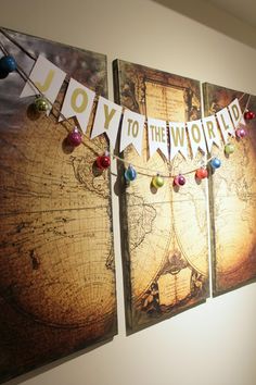 three canvases with the words joy to the world on them hanging from a wall