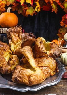 a pile of croissants sitting on top of a plate next to a book