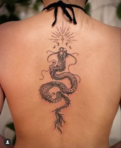 a woman with a dragon tattoo on her back