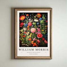 a painting hanging on the wall next to a framed poster with flowers and plants in it