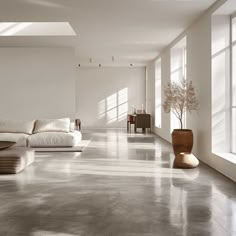 a living room filled with lots of white furniture and large windows on the side of it