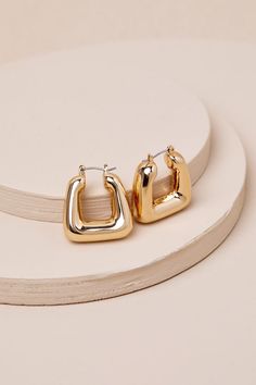 You'll look exquisite from every angle with accessories like the Lulus Precise Perfection Gold Geometric Hoop Earrings! Shiny gold-toned metal shapes these trendy earrings that feature a twist on the classic hollow hoop design thanks to a squared, geometric-inspired silhouette that will make any of your 'fits extra stylish. Hinged Post Backs. 1" Long And 0. 75" Diameter. 100% CCB. Imported. Lulus | Precise Perfection Gold Geometric Hoop Earrings. Trendy Gold Metal Earrings, Trendy Gold Metal Hoop Earrings, Trendy Gold-tone Tarnish Resistant Hoop Earrings, Minimalist Gold Metal Hoop Earrings, Trendy Small Hoop Gold-tone Earrings, Chic Gold-tone Tarnish Resistant Hoop Earrings, Chic Yellow Gold Hoop Earrings, Chic Gold-tone Brass Hoop Earrings, Trendy Gold-tone Metal Hoop Earrings