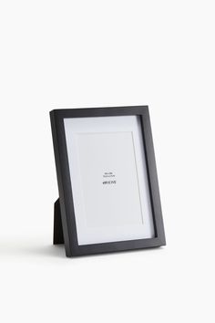 a black and white photo frame sitting on top of a table