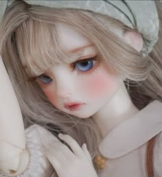 a doll with blonde hair and blue eyes