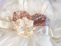 two white and gold flower headbands with sequins on the top one