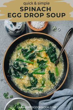 spinach egg drop soup in a bowl with spoons on the side and another bowl next to it