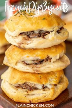 a stack of french dip sandwiches on top of a wooden cutting board with text overlay