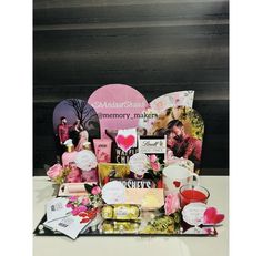 an assortment of valentine's day gifts displayed on a white table with black background