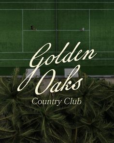 the golden oaks country club is located in front of a green wall and palm trees