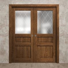 an empty room with two wooden doors on the wall and wood flooring in front of it