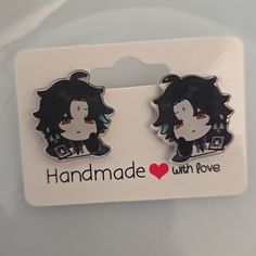 two black and white hair pins with the words handmade with love on them