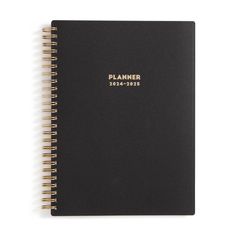 a black planner with gold lettering on it