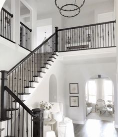 a living room filled with furniture and a staircase