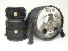 two drum heads are shown next to each other on a white background with black fur