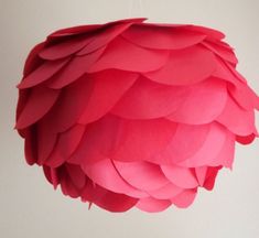 a pink light fixture hanging from a ceiling