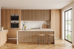 a kitchen with wooden cabinets and stools next to an open floor plan that looks out onto the outdoors