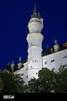 a tall white building with a clock on it's side