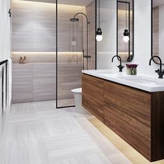 a large bathroom with two sinks and a shower stall in the middle of the room