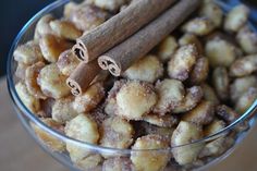 cinnamon sticks in a glass bowl filled with nuts