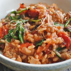 a close up of a bowl of food with rice and vegetables in it on a table