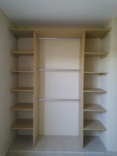 an empty walk in closet with shelves and no doors