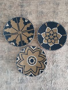 three woven coasters sitting on top of a carpet