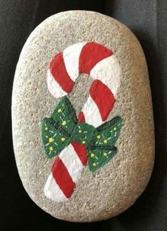 a painted rock with candy canes on it