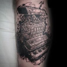 a black and white photo of a car engine tattoo