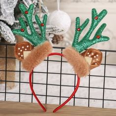 a pair of reindeer ears with green and red decorations