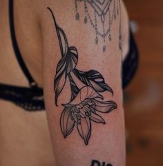 a woman's arm with a flower tattoo on it and the word diff written in black ink